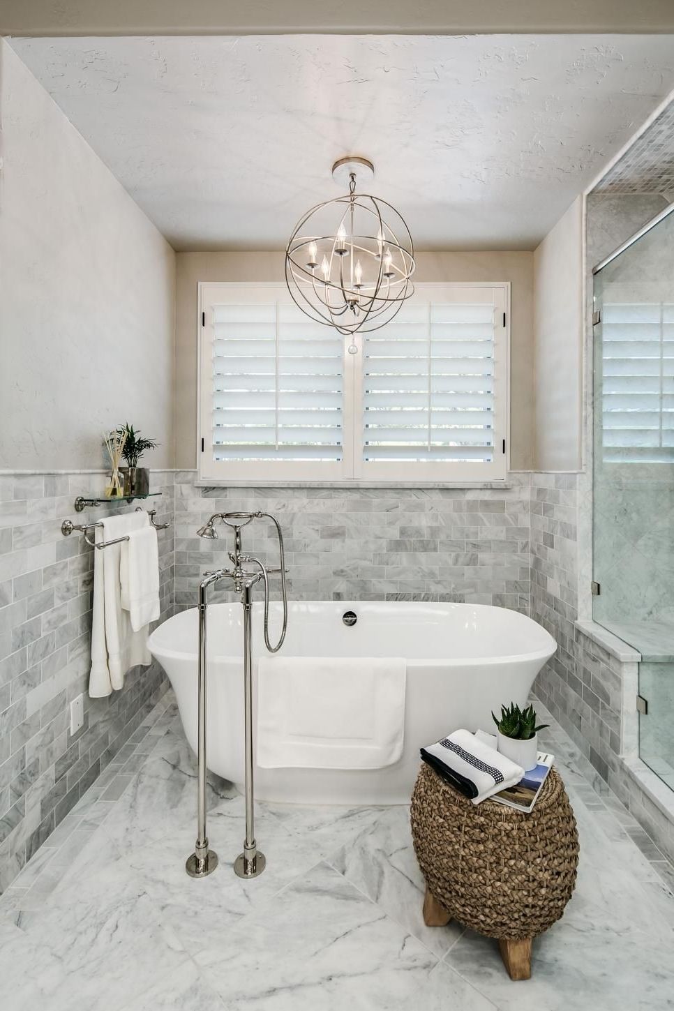 Most Recent Bathroom Chandeliers Regarding A Metal Orb Chandelier Is Centered Above The Freestanding Tub In (View 1 of 15)