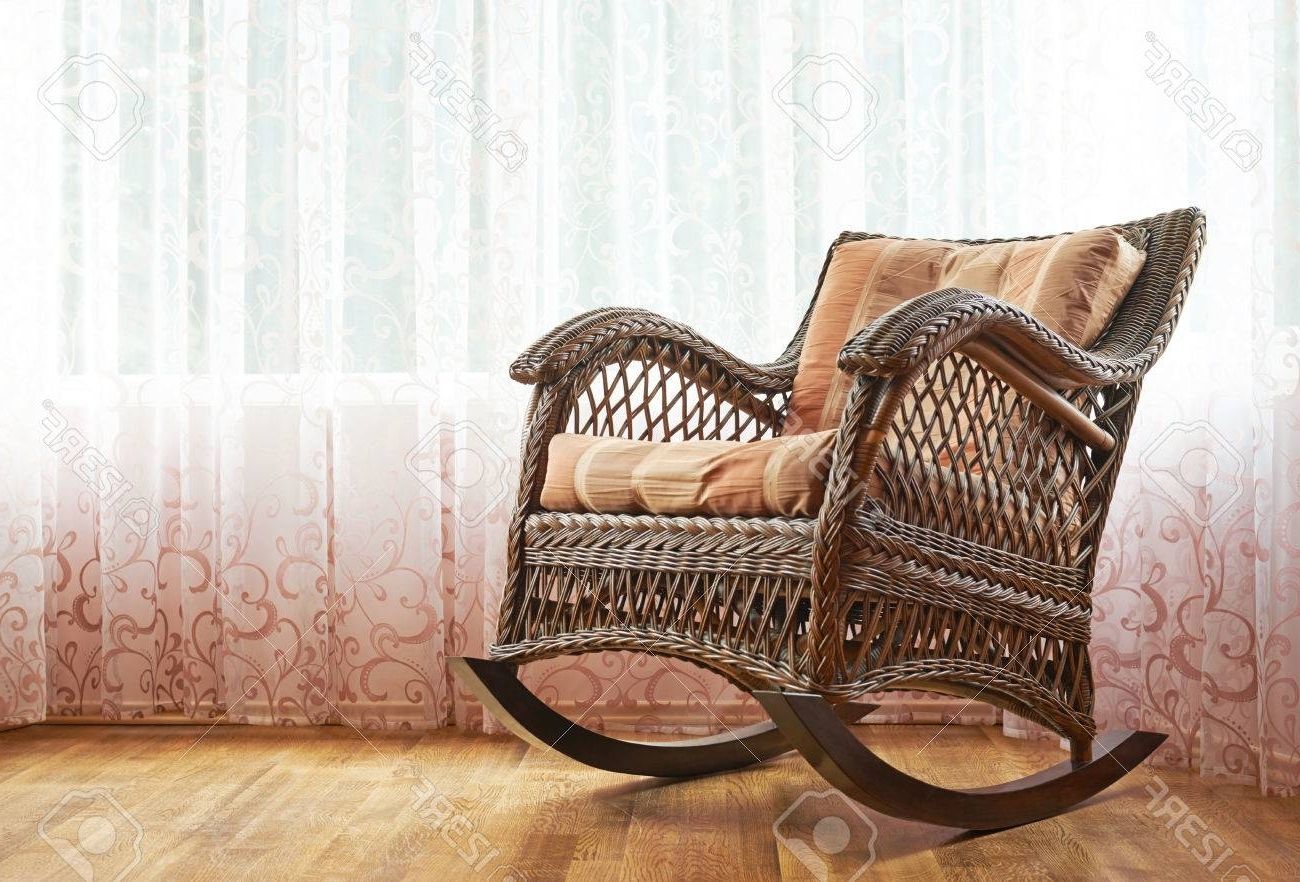 Brown Wicker Rocking Chair Against The Window's Curtains, Indoor Pertaining To Famous Indoor Wicker Rocking Chairs (Photo 1 of 15)