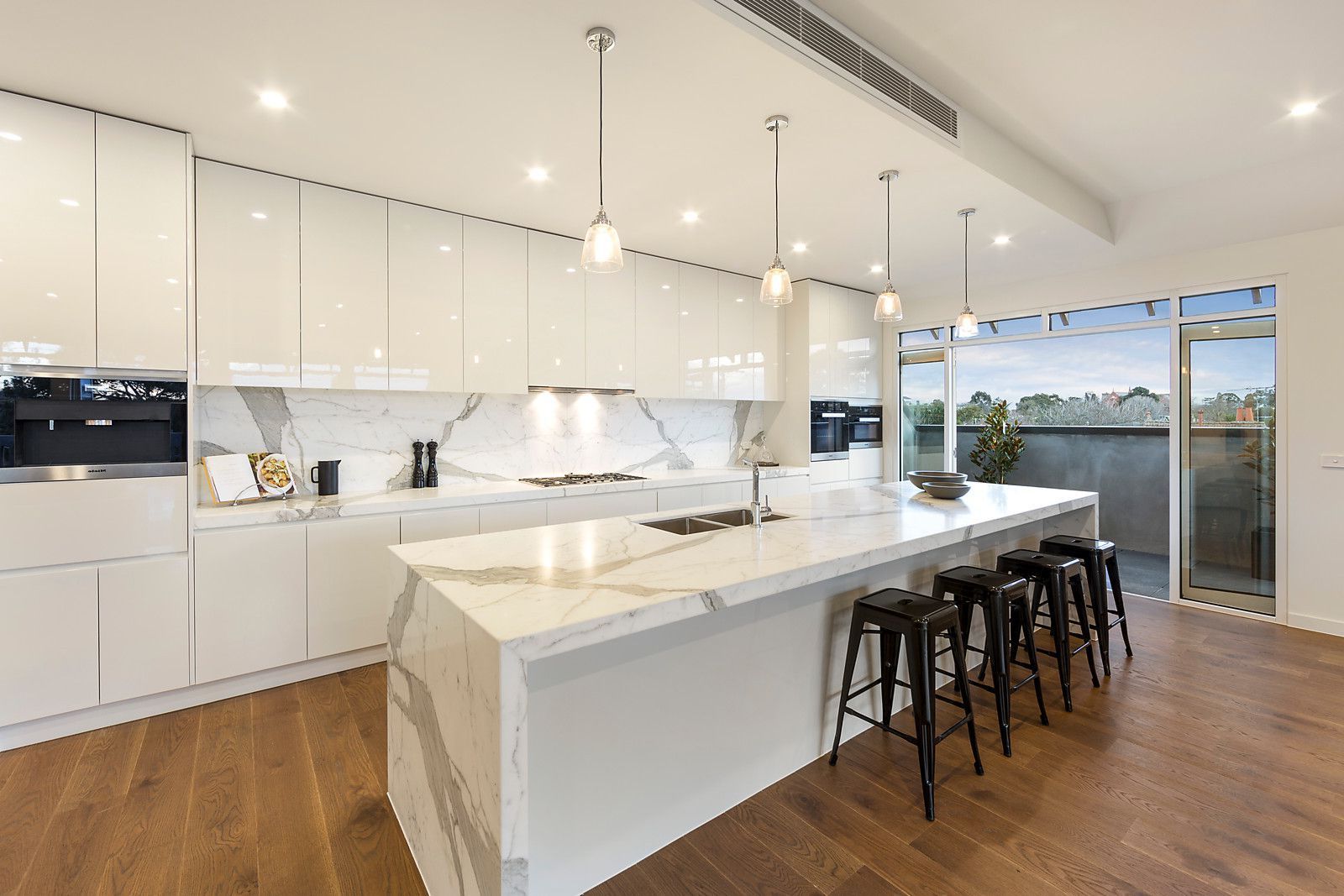 Upland Marble Kitchen Islands With Regard To Well Known Modern White Marble Kitchen With Gloss Cabinetry And Pendant (View 3 of 25)