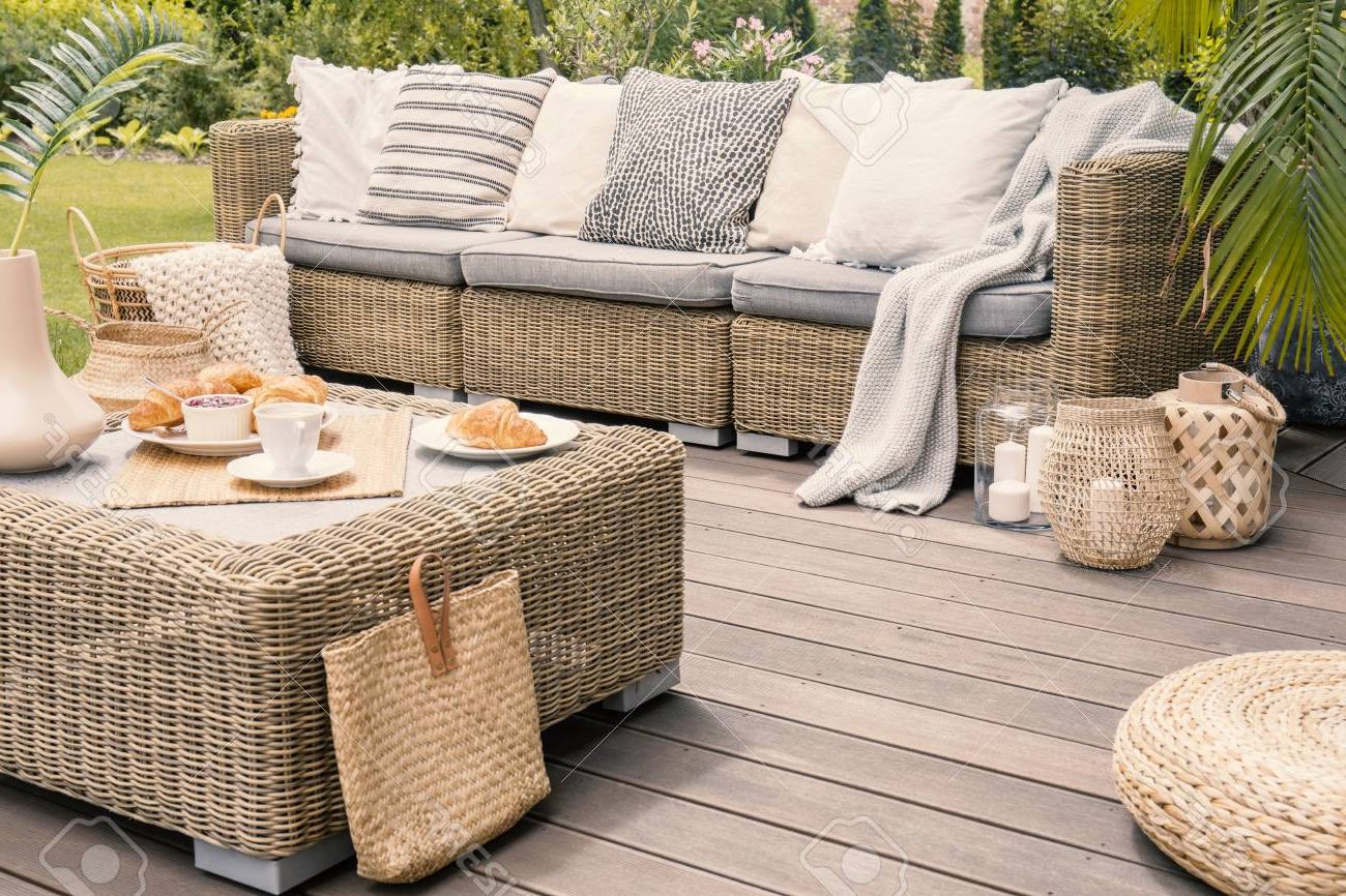 Most Recently Released Balcony Furniture Set With Beige Cushions Pertaining To Wicker Patio Set With Beige Cushions Standing On A Wooden Board Deck.  Breakfast On A Table On A Backyard Porch. Stock Photo, Picture And Royalty  Free Image. Image  (View 14 of 15)